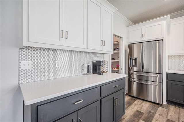 20854 W 190th Pl, Spring Hill, KS 66083 - kitchen with stainless steel refrigerator with ice dispenser, gray cabinets, white cabinetry, light countertops, and ornamental molding
