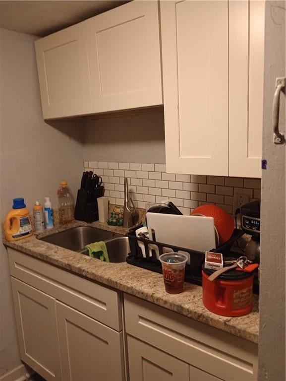 11300 E 29th St, Independence, MO 64052 - kitchen with white cabinetry, decorative backsplash, and light stone countertops