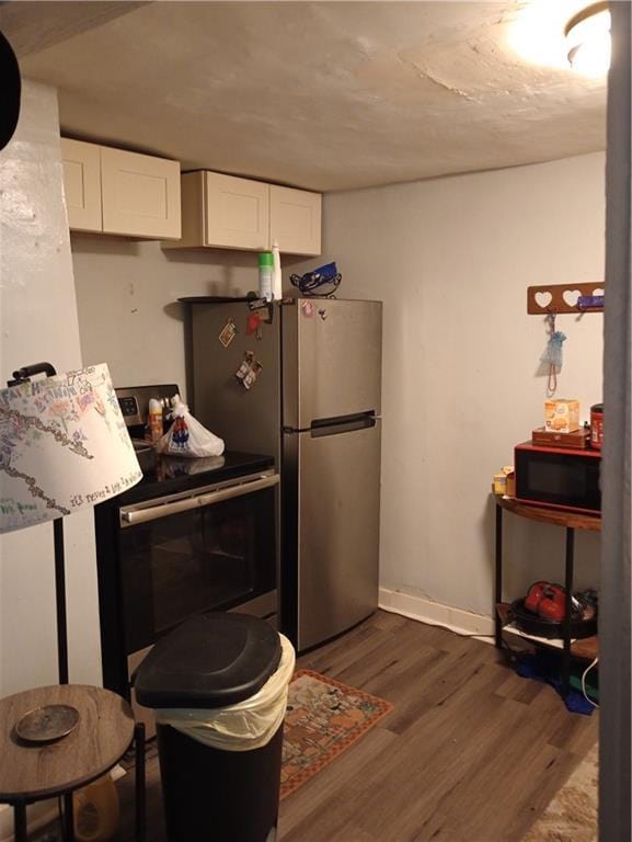 11300 E 29th St, Independence, MO 64052 - kitchen with appliances with stainless steel finishes, dark wood finished floors, and white cabinets