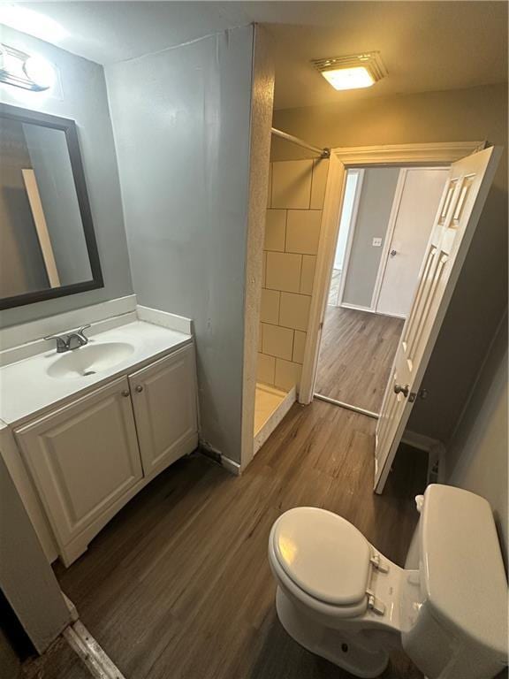 11300 E 29th St, Independence, MO 64052 - full bath with wood finished floors, a shower stall, and vanity