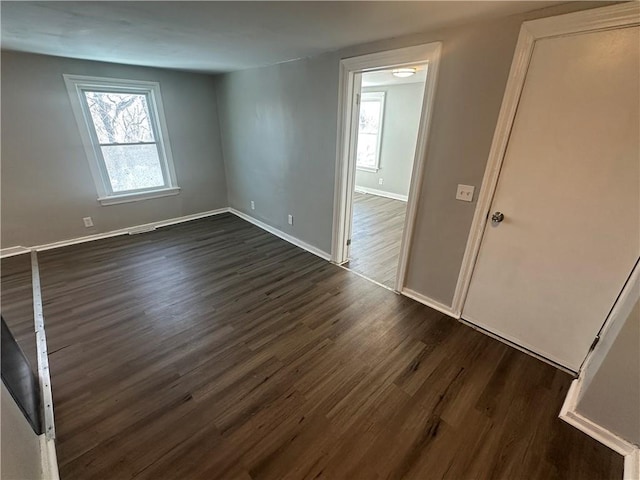 11300 E 29th St, Independence, MO 64052 - spare room featuring dark wood finished floors and baseboards