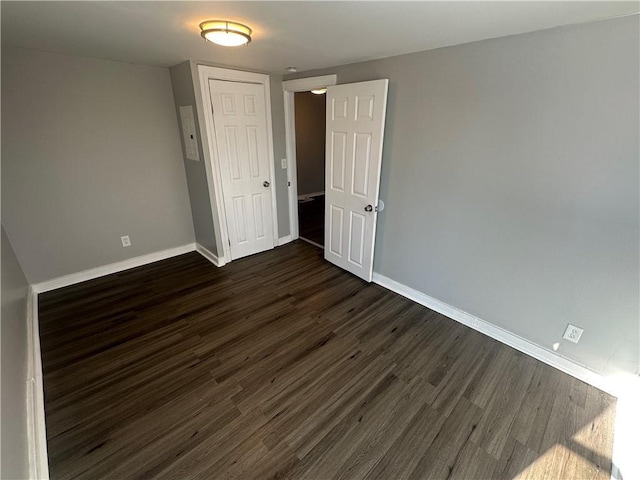 11300 E 29th St, Independence, MO 64052 - unfurnished room featuring dark wood-type flooring and baseboards