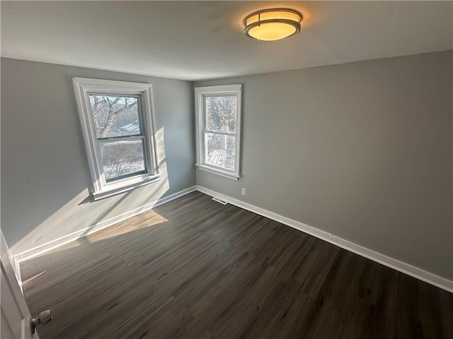11300 E 29th St, Independence, MO 64052 - unfurnished room featuring dark wood-style flooring and plenty of natural light