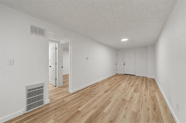 1000 Twin Oaks Ter, Harrisonville, MO 64701 - empty room featuring a textured ceiling and light wood finished floors