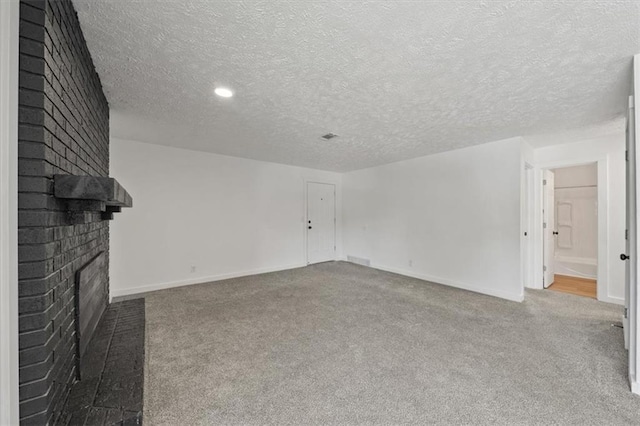 1000 Twin Oaks Ter, Harrisonville, MO 64701 - unfurnished living room with a brick fireplace, carpet floors, and a textured ceiling