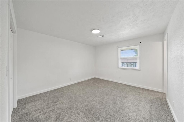 1000 Twin Oaks Ter, Harrisonville, MO 64701 - unfurnished room featuring carpet flooring and a textured ceiling