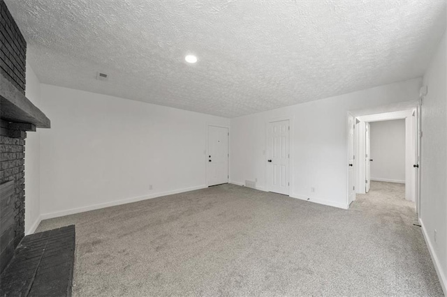 1000 Twin Oaks Ter, Harrisonville, MO 64701 - unfurnished living room with a brick fireplace, carpet flooring, and a textured ceiling
