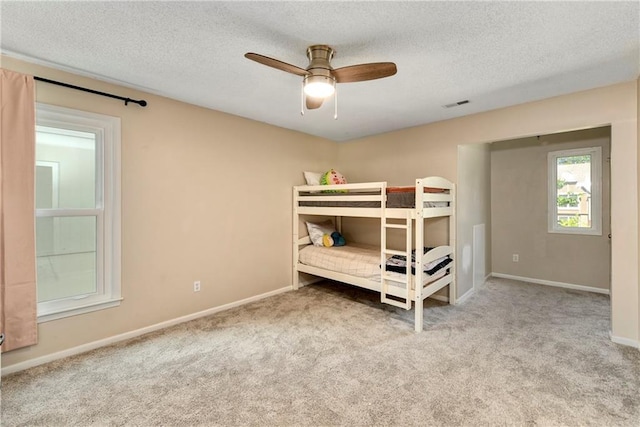 14010 Ash St, Overland Park, KS 66224 - carpeted bedroom featuring a textured ceiling and ceiling fan