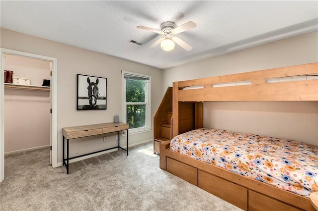 14010 Ash St, Overland Park, KS 66224 - bedroom featuring light carpet, a spacious closet, and a ceiling fan