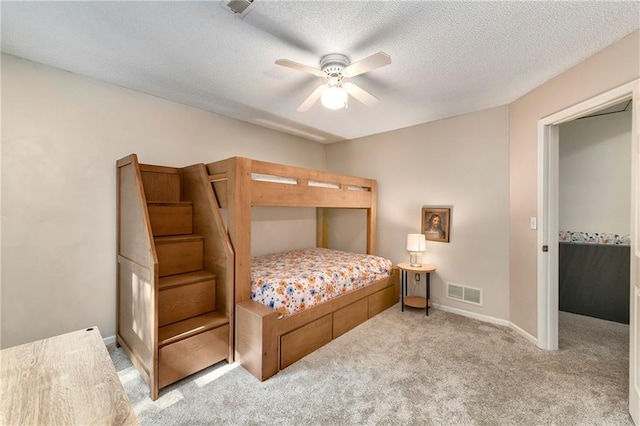 14010 Ash St, Overland Park, KS 66224 - bedroom featuring light colored carpet, a textured ceiling, and a ceiling fan