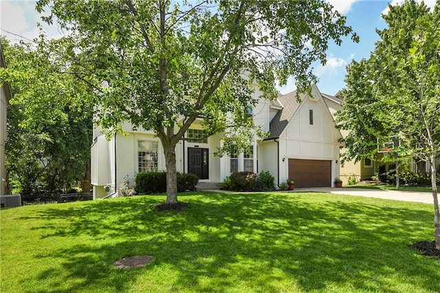 14010 Ash St, Overland Park, KS 66224 - view of front of house featuring driveway and a front lawn