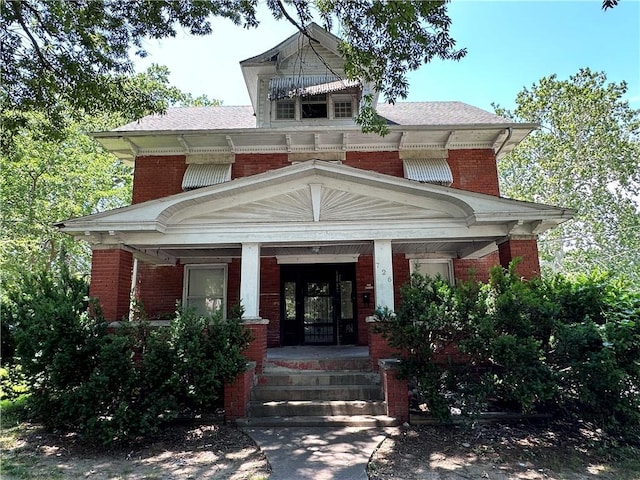 726 N River Blvd, Independence, MO 64050 - view of front facade featuring brick siding and covered porch