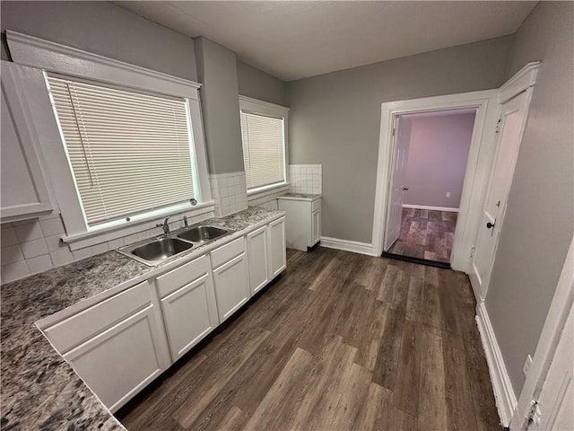 726 N River Blvd, Independence, MO 64050 - kitchen with dark wood-type flooring, white cabinetry, and decorative backsplash