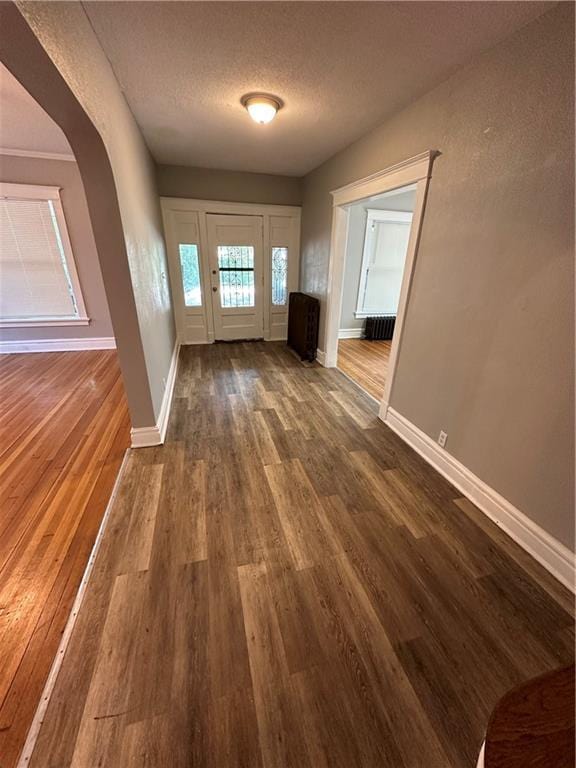 726 N River Blvd, Independence, MO 64050 - entryway featuring dark wood finished floors and a textured ceiling