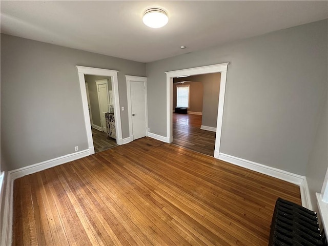 726 N River Blvd, Independence, MO 64050 - spare room featuring wood-type flooring and baseboards
