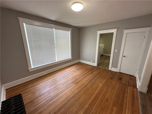 726 N River Blvd, Independence, MO 64050 - unfurnished bedroom featuring hardwood / wood-style flooring and baseboards