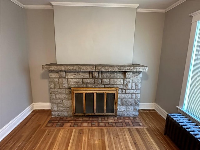 726 N River Blvd, Independence, MO 64050 - detailed view of radiator, a fireplace, wood finished floors, and crown molding