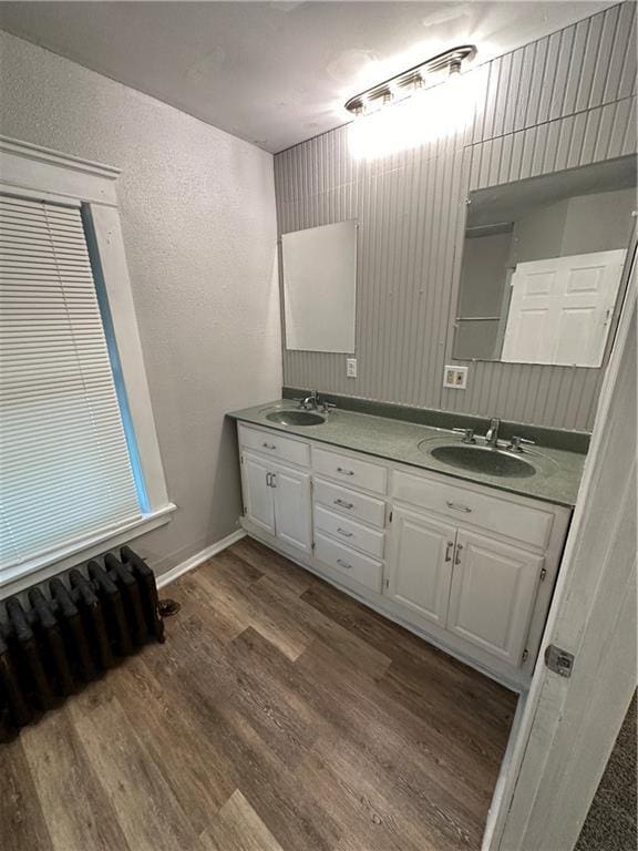 726 N River Blvd, Independence, MO 64050 - bathroom featuring double vanity and wood finished floors