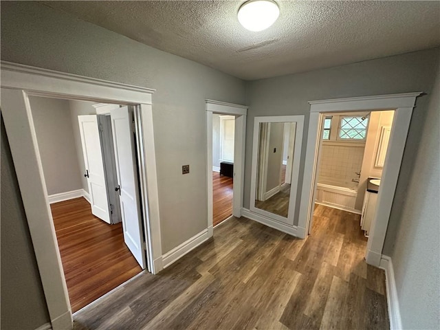 726 N River Blvd, Independence, MO 64050 - hallway with dark wood-style flooring and a textured ceiling