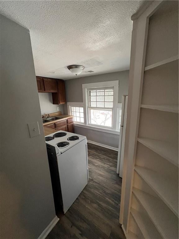 726 N River Blvd, Independence, MO 64050 - kitchen with white appliances, a textured ceiling, dark wood-style floors, and light countertops