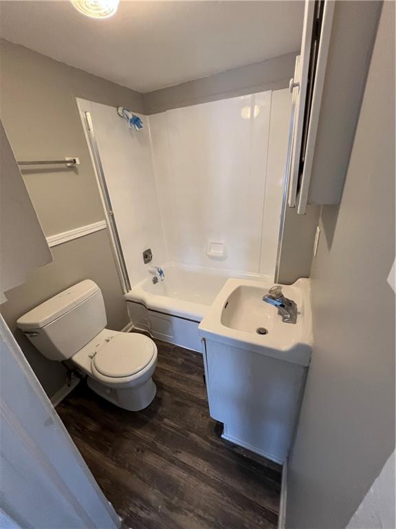 726 N River Blvd, Independence, MO 64050 - full bath featuring wood finished floors, vanity, and bathing tub / shower combination