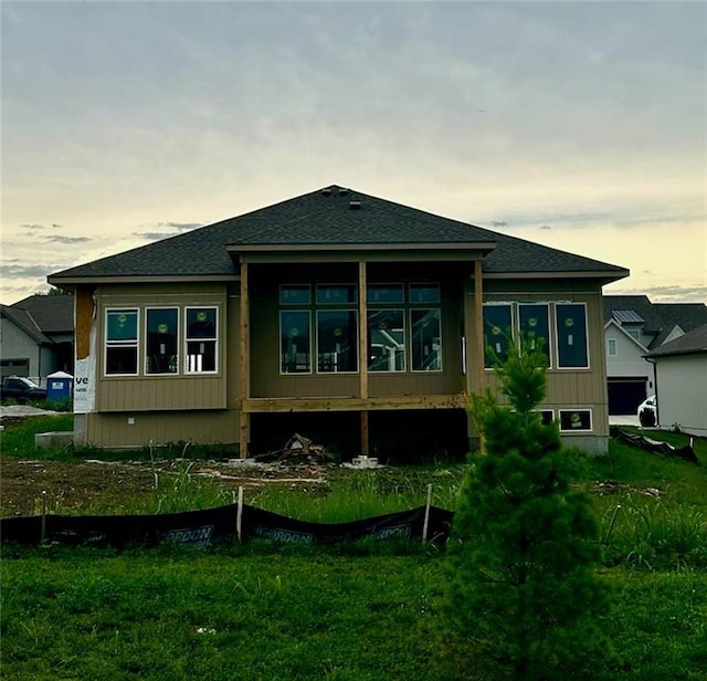 17404 Crystal St, Overland Park, KS 66221 - back of house featuring roof with shingles and a sunroom