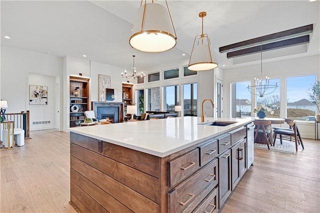 17404 Crystal St, Overland Park, KS 66221 - kitchen with a chandelier, light wood-style floors, a kitchen island with sink, and recessed lighting