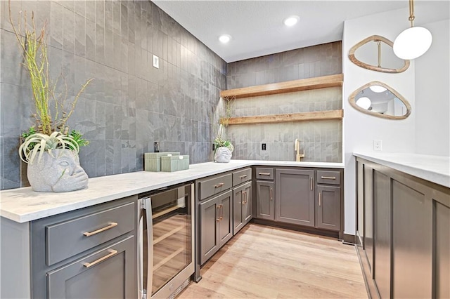 17404 Crystal St, Overland Park, KS 66221 - bar with beverage cooler, light wood finished floors, tasteful backsplash, recessed lighting, and decorative light fixtures