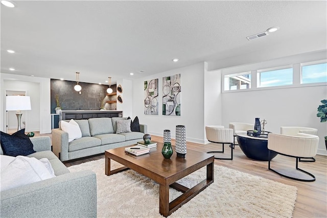 17404 Crystal St, Overland Park, KS 66221 - living room featuring light wood-type flooring, recessed lighting, and a textured ceiling