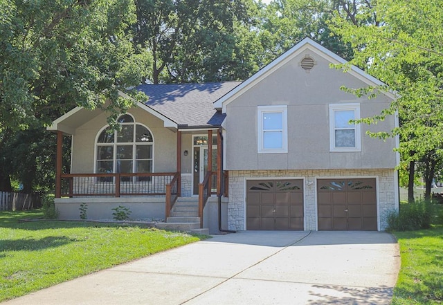 311 NE Bridge Pl, Blue Springs, MO 64014 - tri-level home with an attached garage, concrete driveway, covered porch, stucco siding, and a front lawn