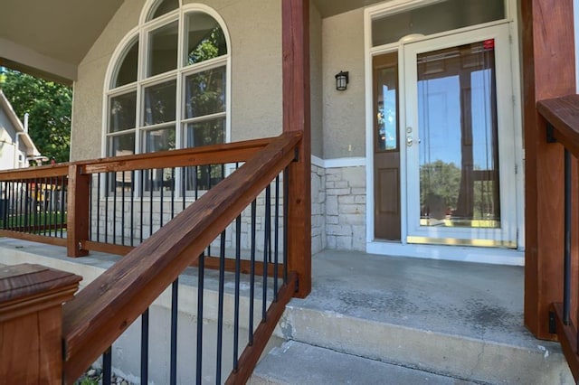 311 NE Bridge Pl, Blue Springs, MO 64014 - property entrance featuring stone siding, stucco siding, and covered porch