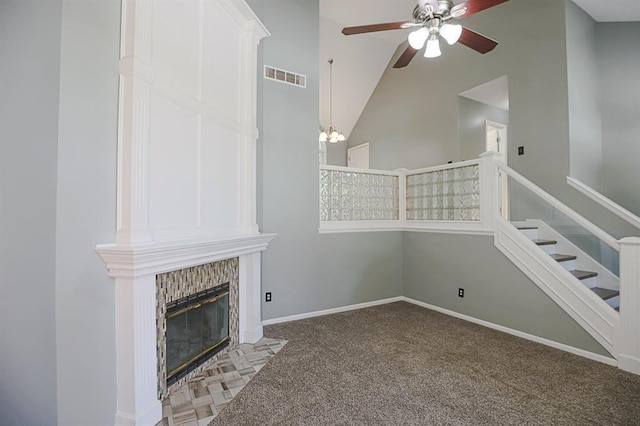 311 NE Bridge Pl, Blue Springs, MO 64014 - unfurnished living room featuring carpet, ceiling fan, a fireplace, stairway, and high vaulted ceiling