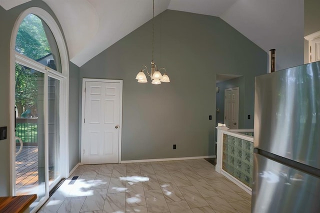 311 NE Bridge Pl, Blue Springs, MO 64014 - unfurnished dining area featuring a chandelier, high vaulted ceiling, and light marble finish floors