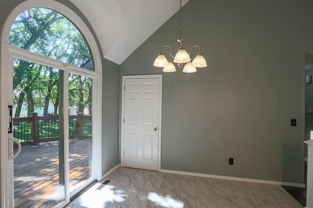 311 NE Bridge Pl, Blue Springs, MO 64014 - doorway with a chandelier, light marble finish floors, and high vaulted ceiling