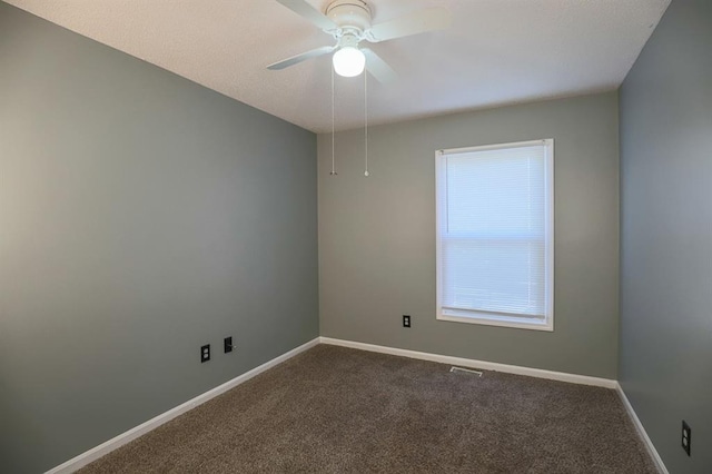 311 NE Bridge Pl, Blue Springs, MO 64014 - spare room featuring dark carpet and ceiling fan