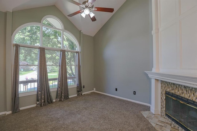 311 NE Bridge Pl, Blue Springs, MO 64014 - unfurnished living room featuring ceiling fan, vaulted ceiling, healthy amount of natural light, light carpet, and a tile fireplace