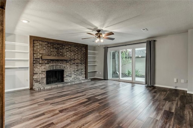 10734 Glenwood St Unit A, Overland Park, KS 66211 - unfurnished living room featuring a textured ceiling, ceiling fan, wood finished floors, a brick fireplace, and built in features