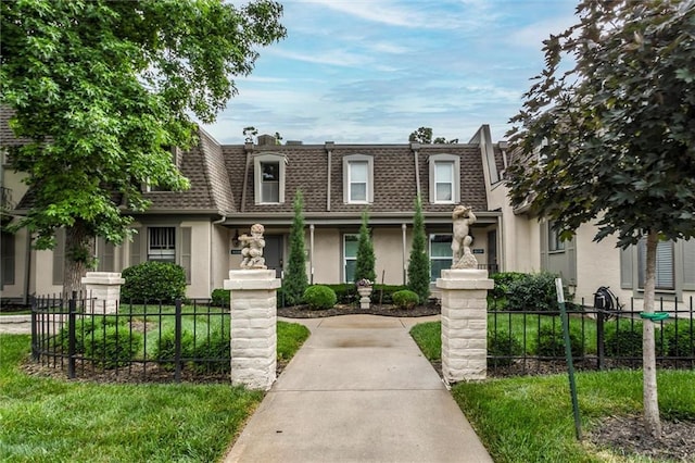 10734 Glenwood St Unit A, Overland Park, KS 66211 - view of front of home with mansard roof, roof with shingles, and stucco siding