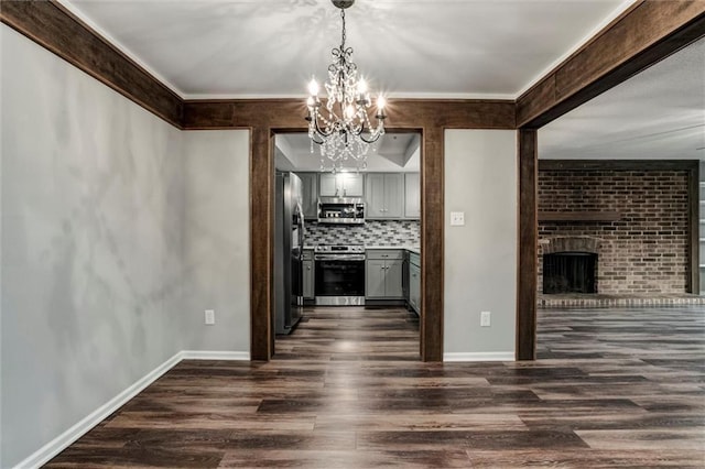 10734 Glenwood St Unit A, Overland Park, KS 66211 - kitchen with appliances with stainless steel finishes, a chandelier, gray cabinets, dark wood-type flooring, and backsplash