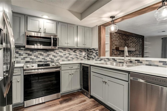 10734 Glenwood St Unit A, Overland Park, KS 66211 - kitchen with appliances with stainless steel finishes, gray cabinets, beverage cooler, a textured ceiling, and light countertops