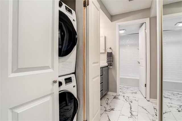 10734 Glenwood St Unit A, Overland Park, KS 66211 - washroom featuring stacked washer and clothes dryer and light marble finish flooring