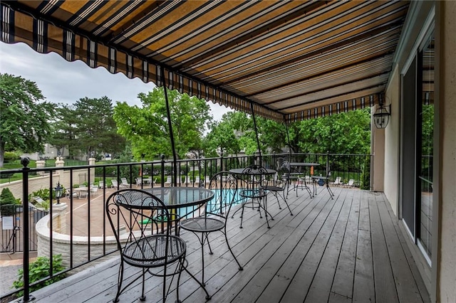 10734 Glenwood St Unit A, Overland Park, KS 66211 - wooden deck featuring outdoor dining space