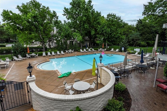 10734 Glenwood St Unit A, Overland Park, KS 66211 - community pool with a patio area and view of scattered trees