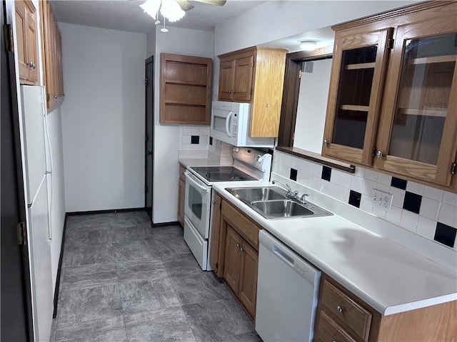 423 W 104th St Unit C, Kansas City, MO 64114 - kitchen featuring white appliances, open shelves, backsplash, brown cabinetry, and light countertops