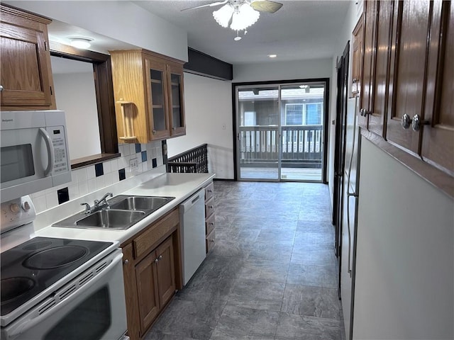 423 W 104th St Unit C, Kansas City, MO 64114 - kitchen featuring white appliances, backsplash, a ceiling fan, light countertops, and glass insert cabinets