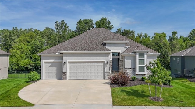 14500 Aurora Ln, Basehor, KS 66007 - prairie-style home featuring stucco siding, stone siding, an attached garage, and concrete driveway