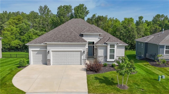 14500 Aurora Ln, Basehor, KS 66007 - view of front of house featuring a garage, stucco siding, stone siding, concrete driveway, and roof with shingles