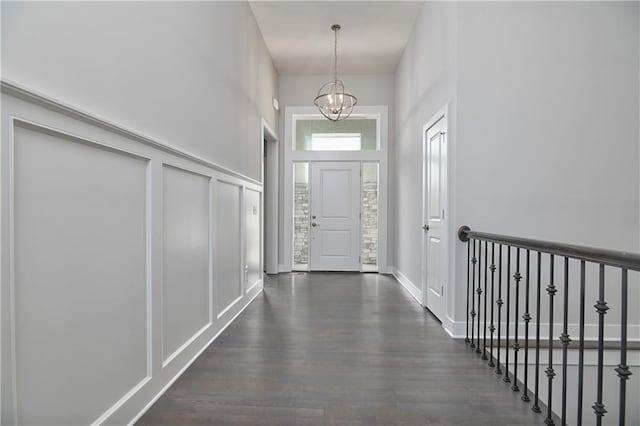 14500 Aurora Ln, Basehor, KS 66007 - entryway featuring a towering ceiling, dark wood-style floors, a chandelier, and a decorative wall