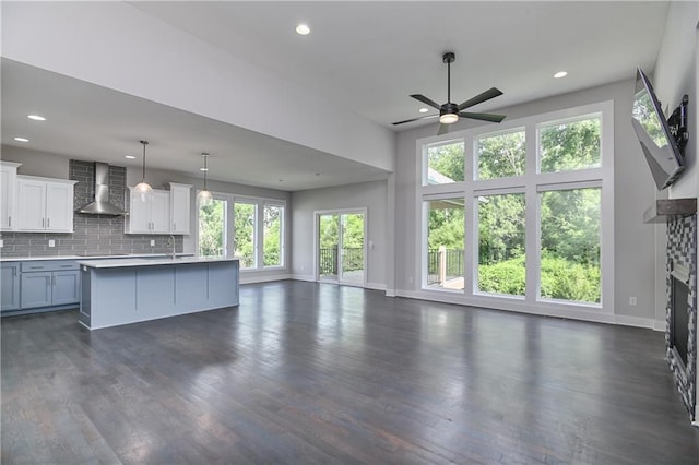 14500 Aurora Ln, Basehor, KS 66007 - kitchen with wall chimney range hood, open floor plan, ceiling fan, dark wood-style flooring, and recessed lighting