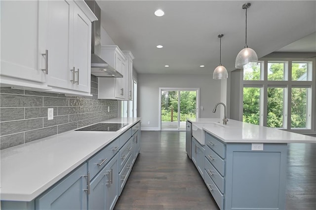 14500 Aurora Ln, Basehor, KS 66007 - kitchen featuring black electric stovetop, wall chimney exhaust hood, light countertops, white cabinetry, and dark wood-style flooring